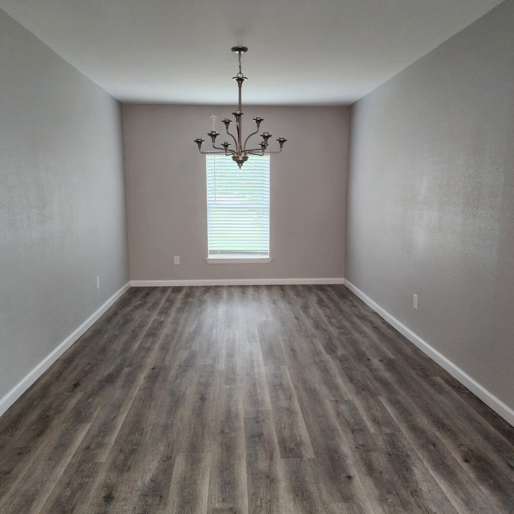 remodeled dining room with new laminate flooring and new chandelier